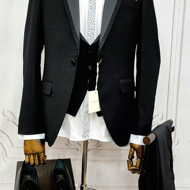 Single Button Three Pieces Tuxedo Suit with Black satin Lapel, matching bow tie and black dress pants.